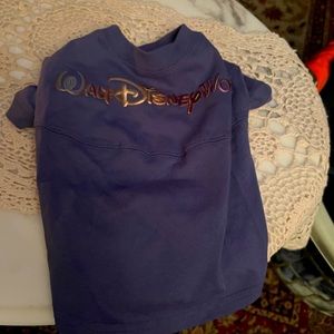 Dog shirts. one is the 50th anniversary and they both say Walt Disney on items.